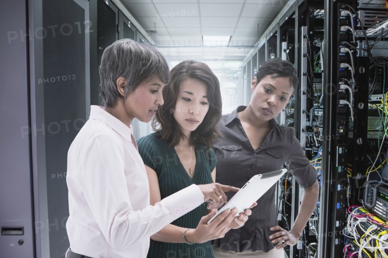 Businesswomen working together in server room