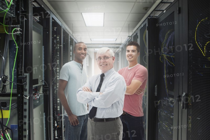 Businessmen standing in server room