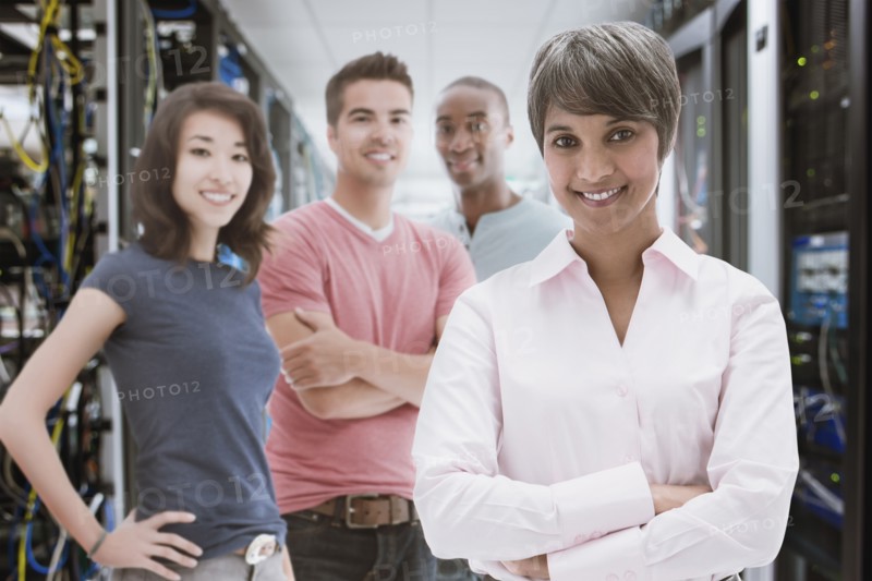 Business people standing in server room