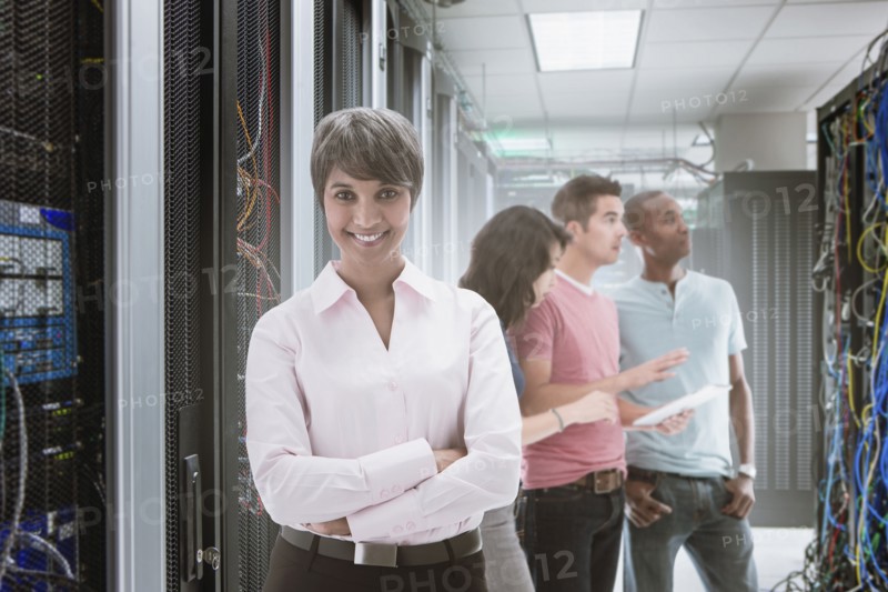Business people standing in server room