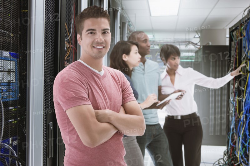 Business people standing in server room