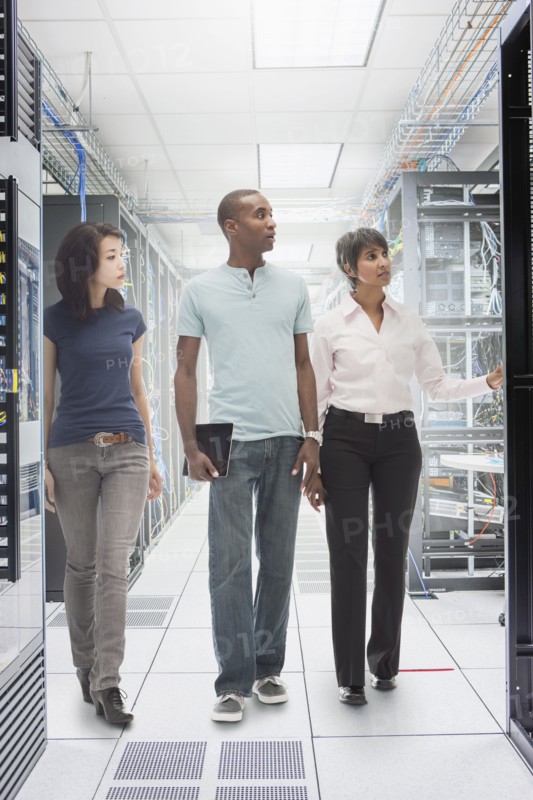 Business people working in server room