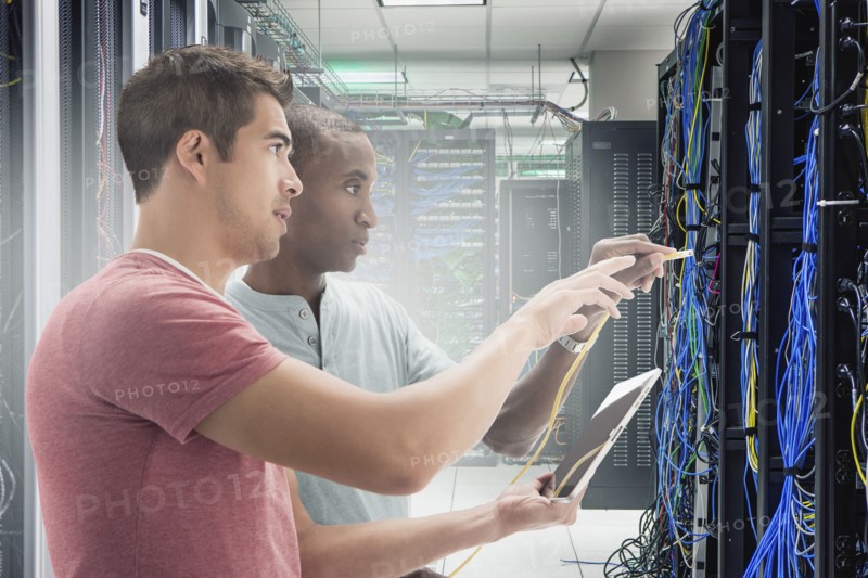 Businessmen working in server room