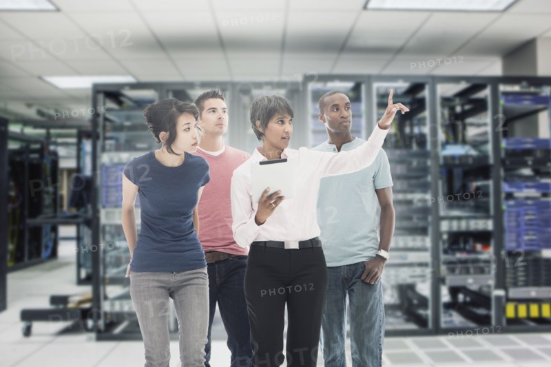 Business people working in server room