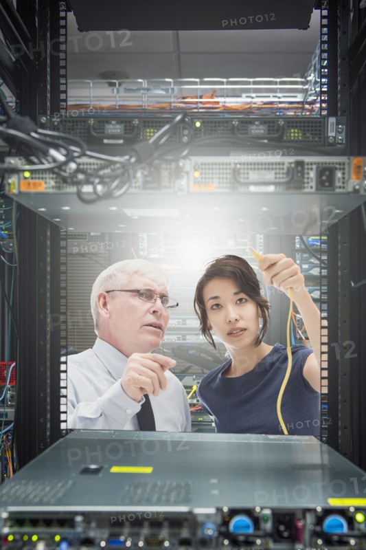 Business people working in server room