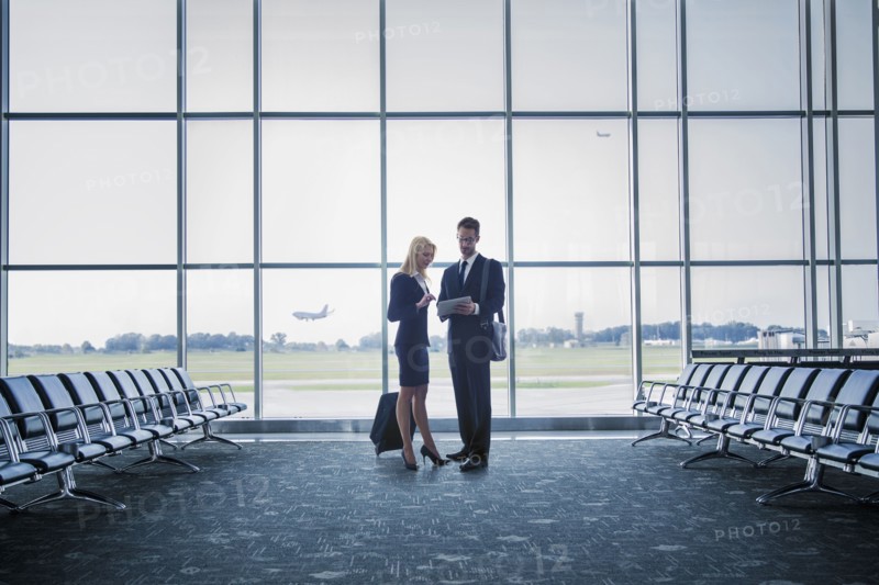 Caucasian business people standing in airport