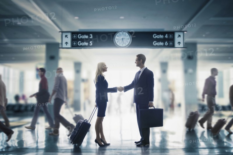 Business people shaking hands in airport