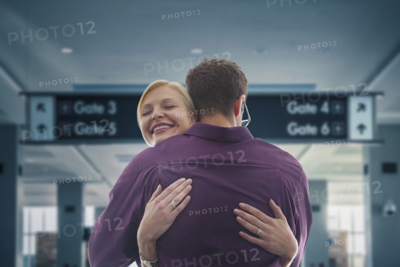 Caucasian hugging in airport