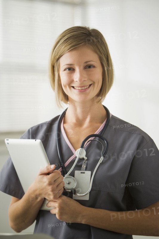 Caucasian nurse holding digital tablet