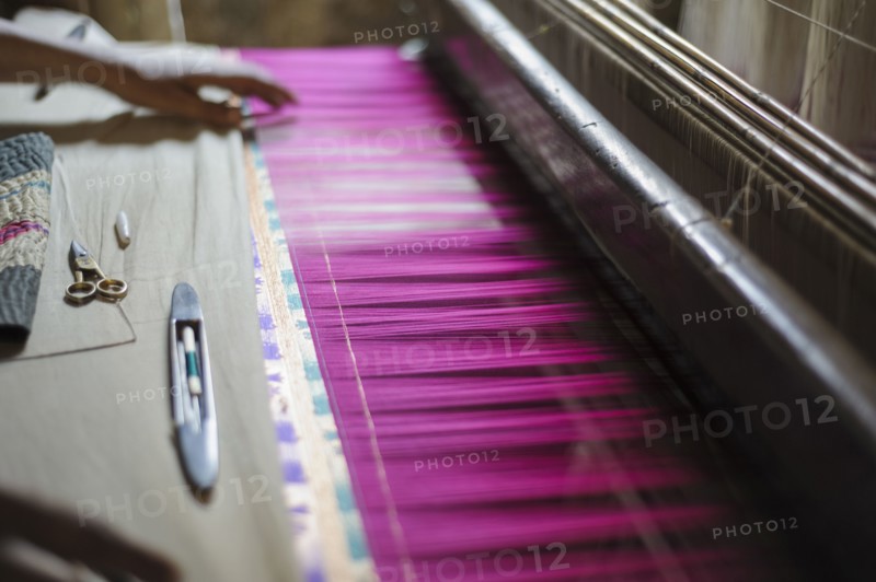 Hand feeling threads in loom