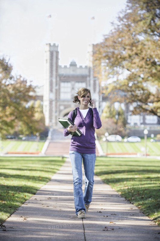 Caucasian student on cell phone on campus