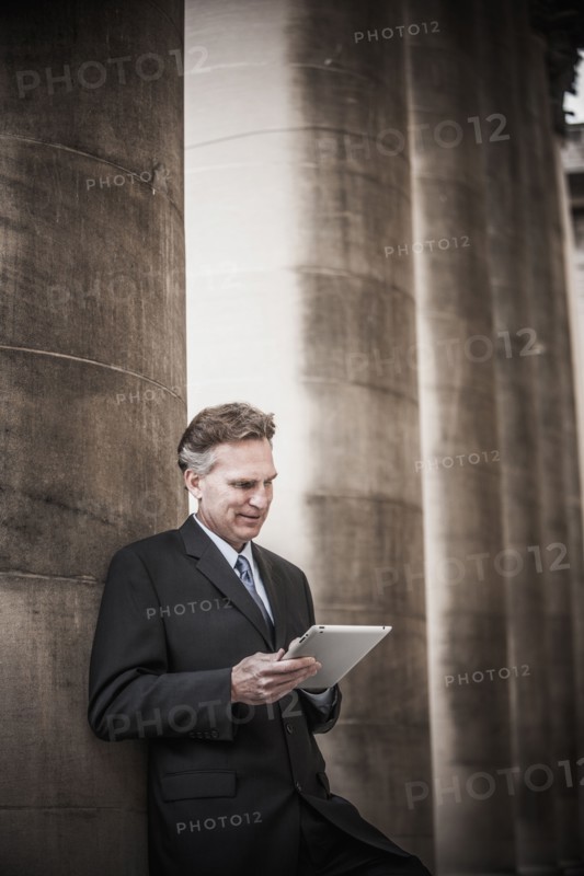 Caucasian businessman using tablet computer
