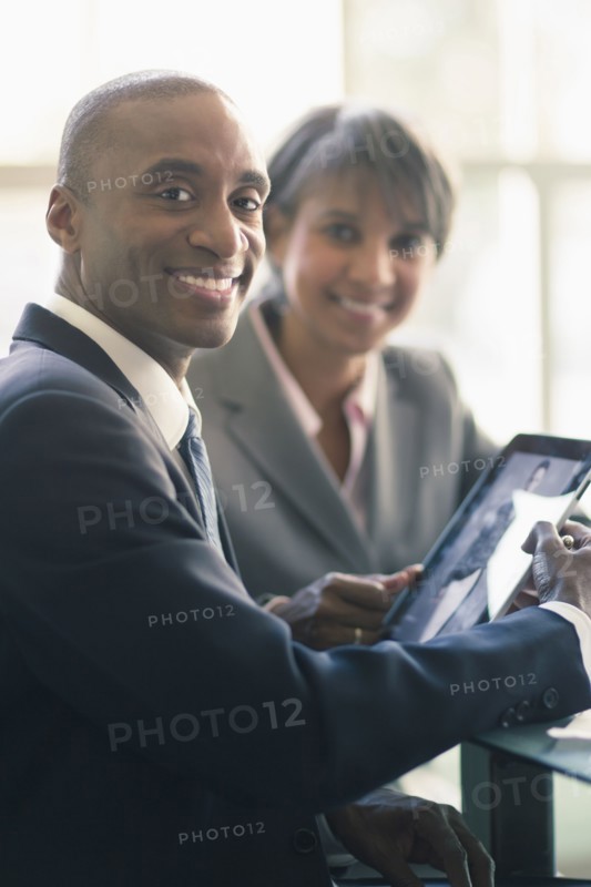 Black business people using tablet computer