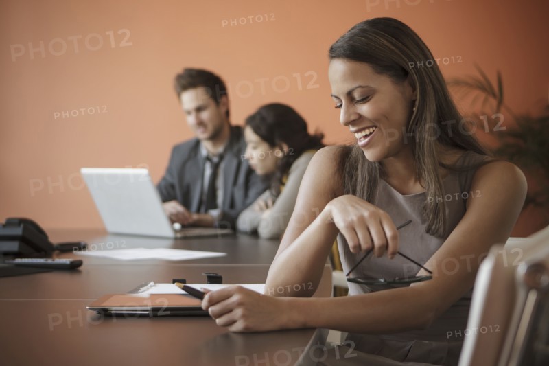 Businesswoman using tablet computer at desk