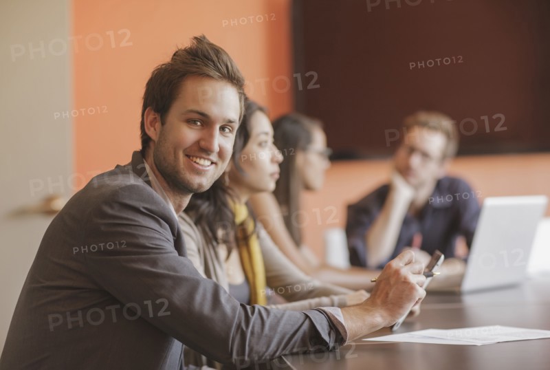 Caucasian businessman smiling in meeting