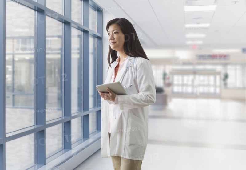 Asian doctor walking in hospital