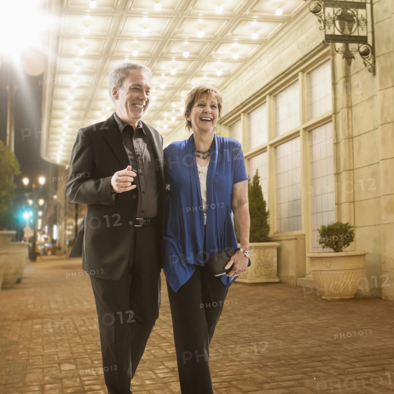 Caucasian couple walking on city street