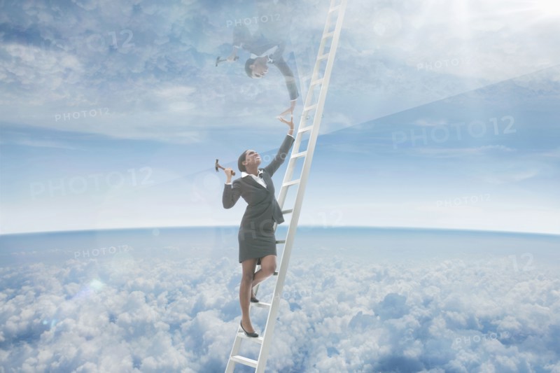 African American businesswoman on ladder to glass ceiling