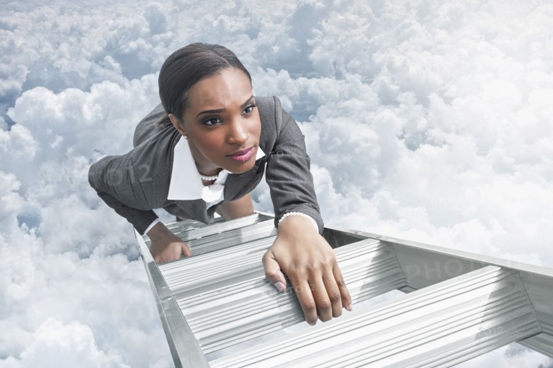 African American businesswoman climbing ladder