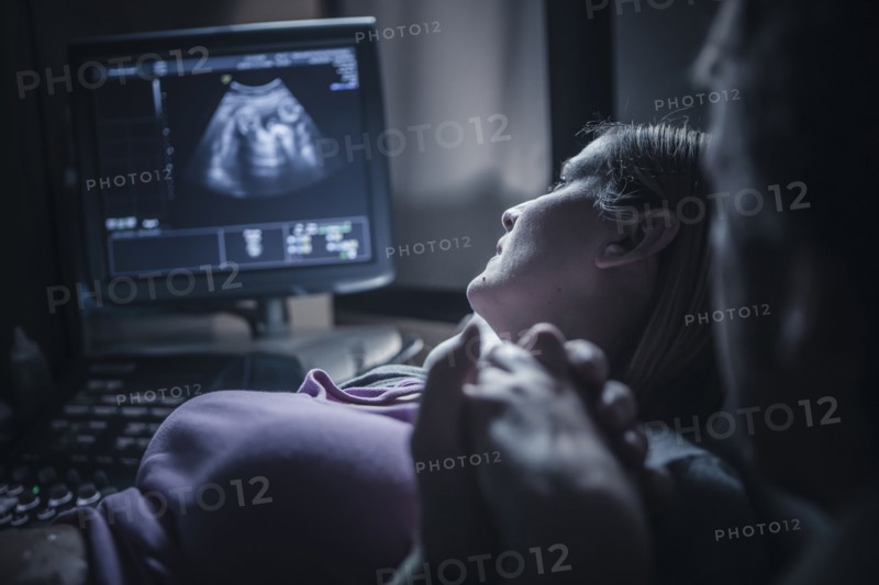 Pregnant couple having sonogram