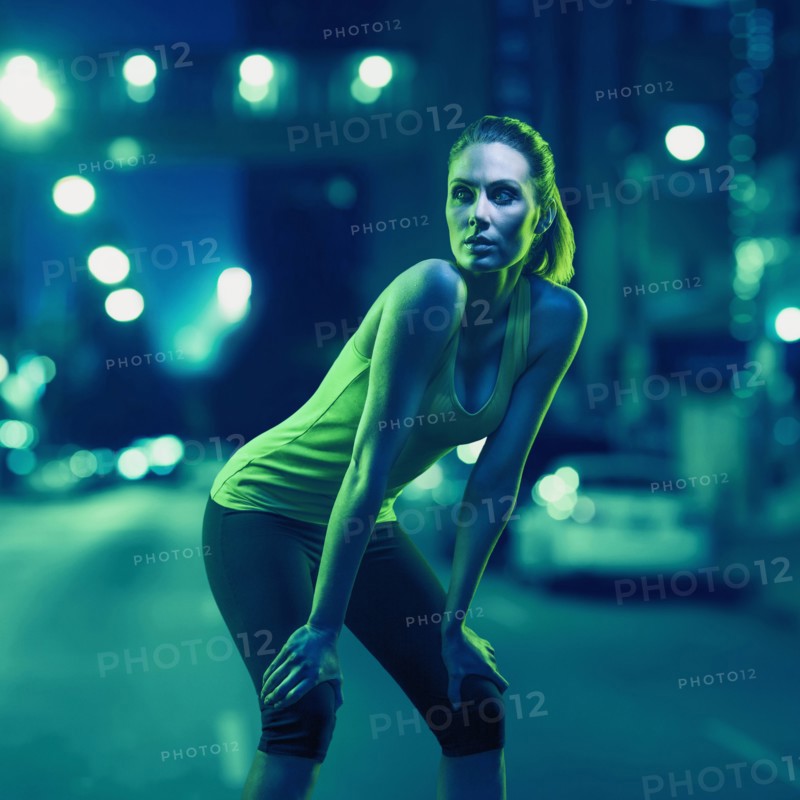 Caucasian runner standing on city street