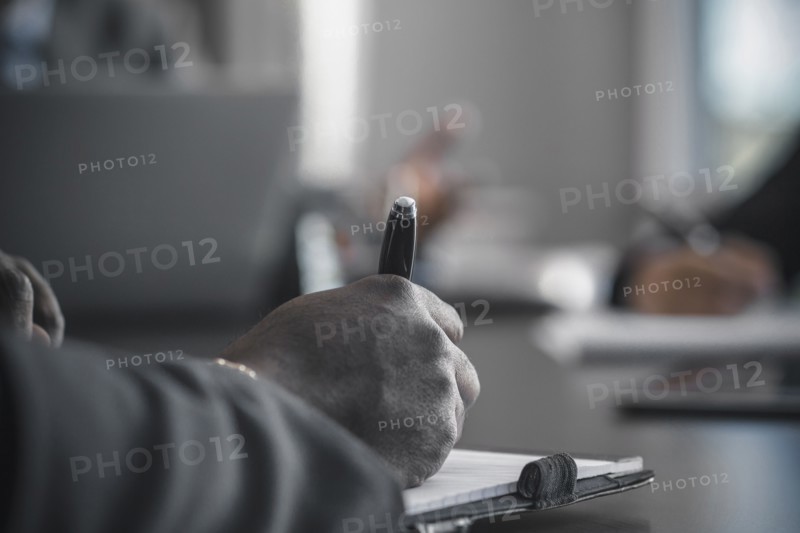 Businessman taking notes in meeting