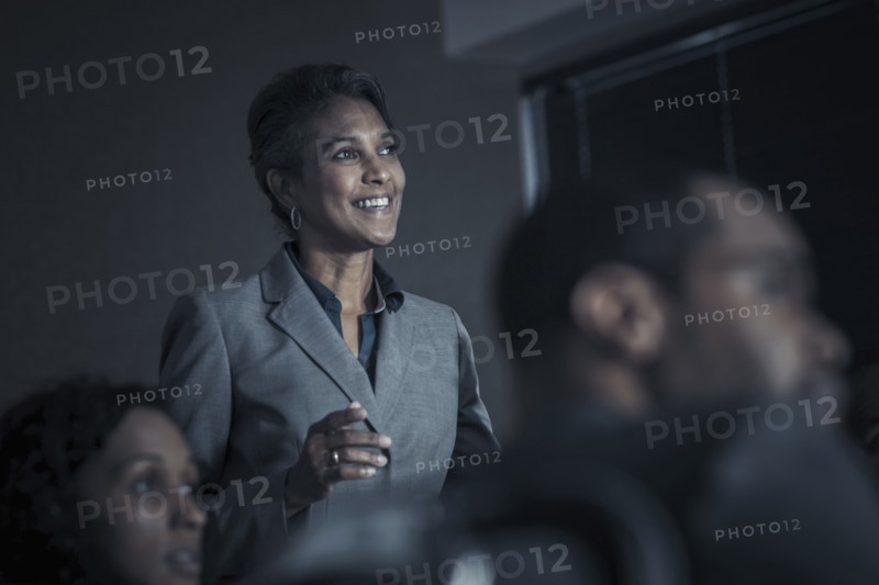 Business people watching audio visual presentation in meeting
