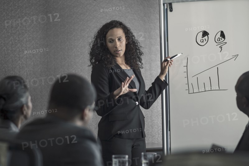Businesswoman talking to colleagues in meeting