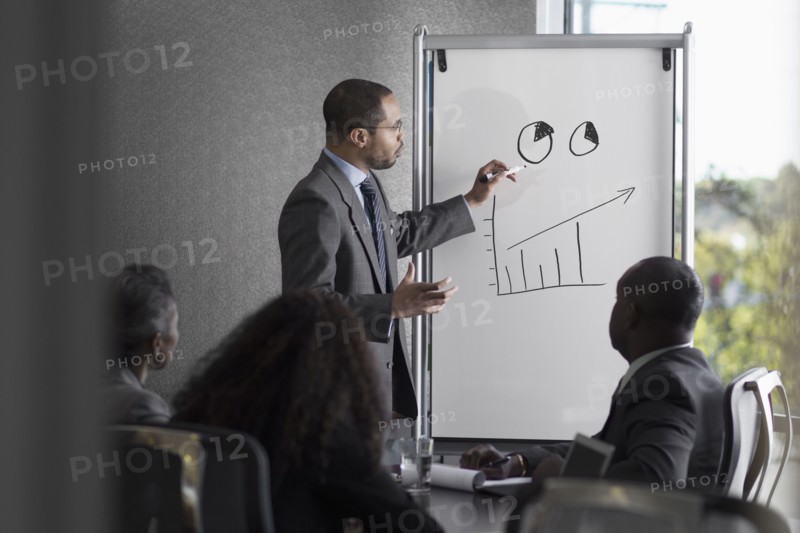 Businessman talking to colleagues in meeting