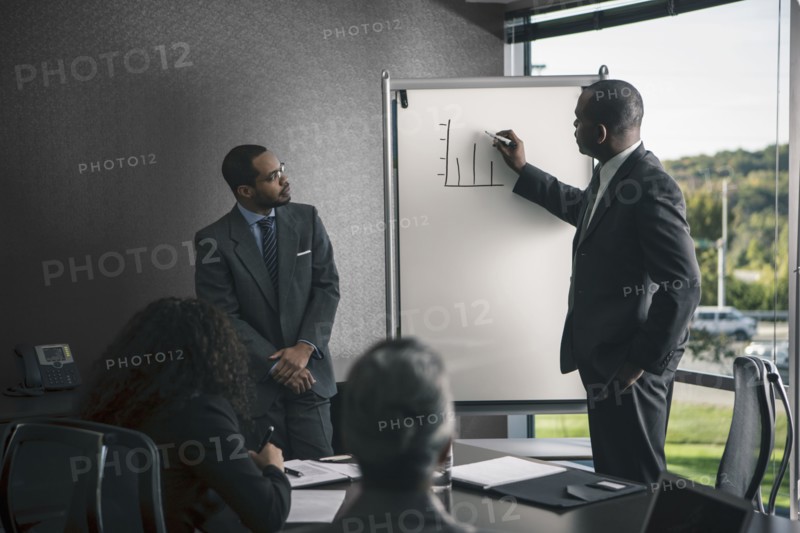 Businessman talking to colleagues in meeting
