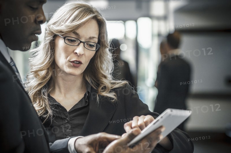 Business people using digital tablet in office