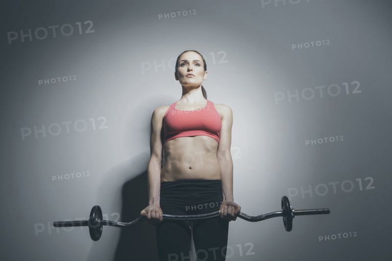 Caucasian woman holding barbell