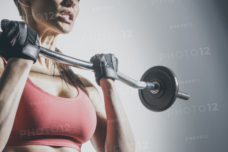 Caucasian woman lifting barbell