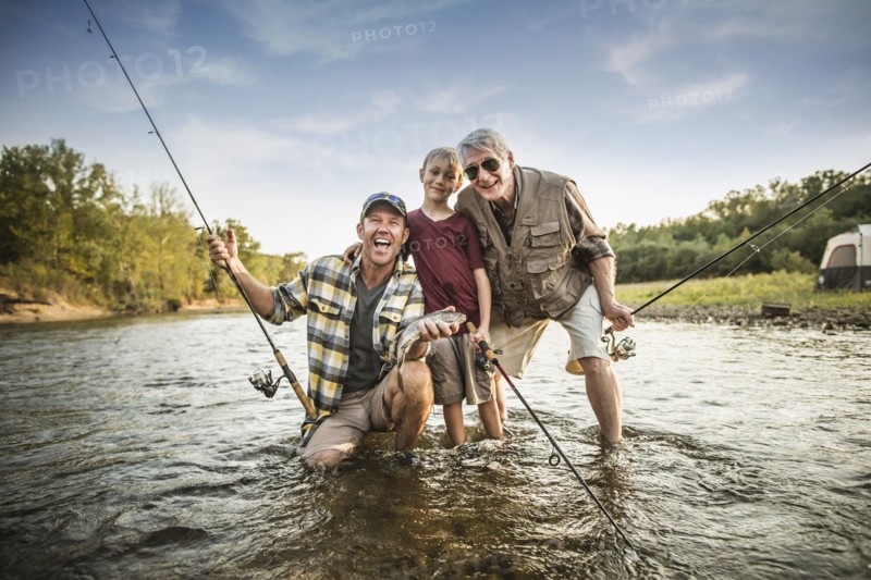 Three generations of Caucasian men fishing in river