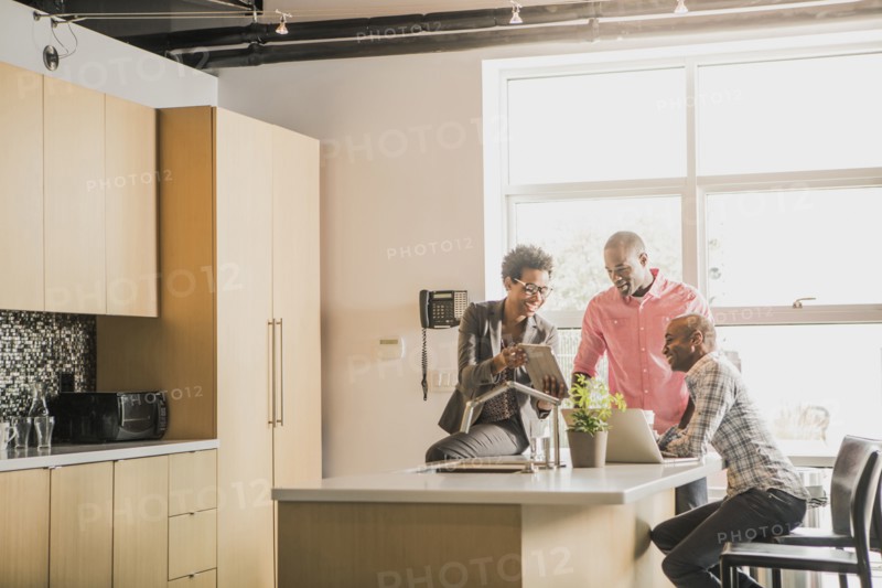 Business people talking in office kitchen