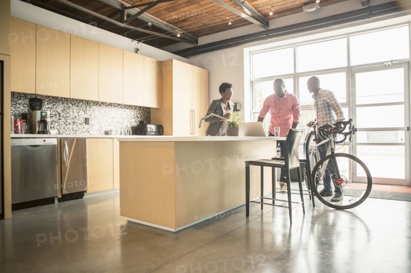 Business people talking in office kitchen