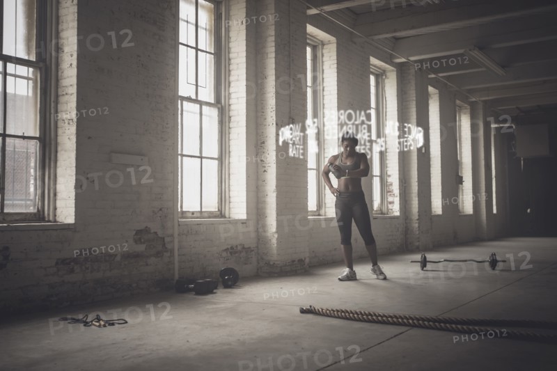 Virtual words circling Black athlete checking fitness tracker