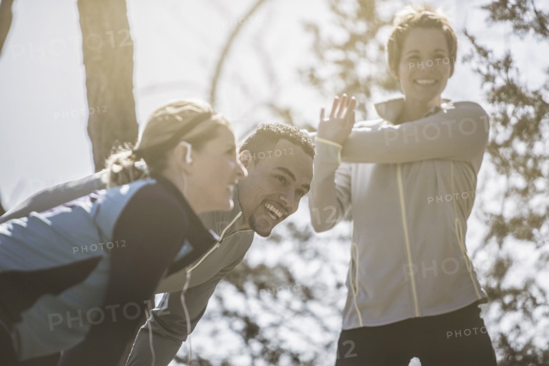Close up of smiling athletes stretching