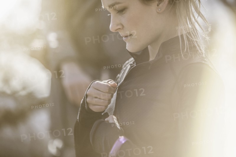Close up of Caucasian woman zipping jacket