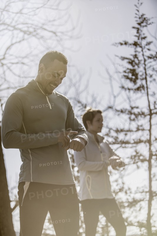 Athletes checking sports watches