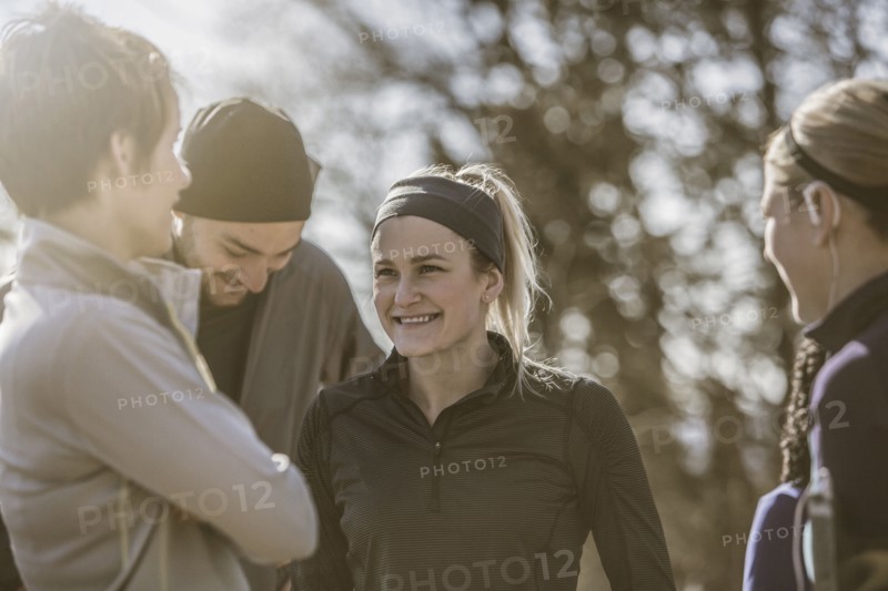 Smiling friends talking outdoors