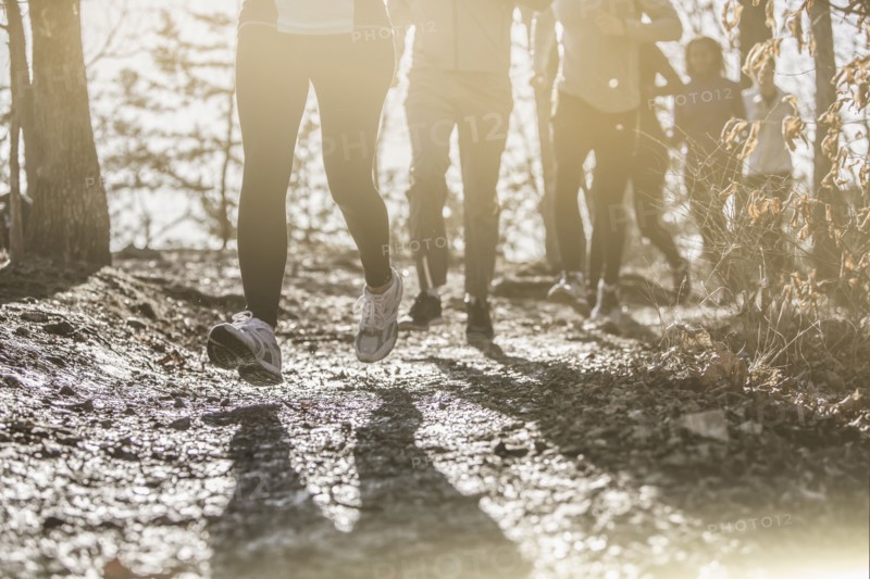 Runners jogging on dirt path