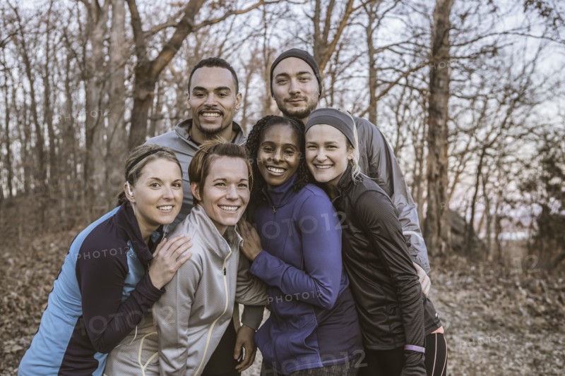 Runners smiling on forest path