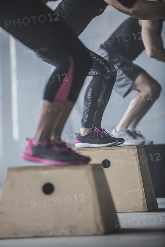 Athletes jumping on platforms in gym