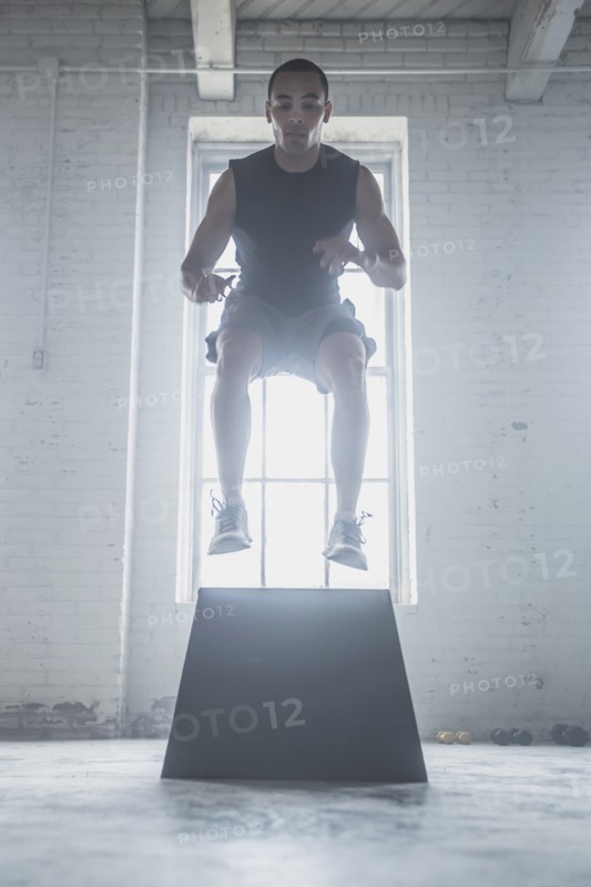 Athlete jumping on platform