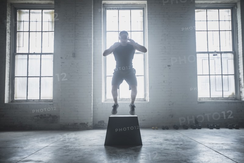 Athlete jumping on platform