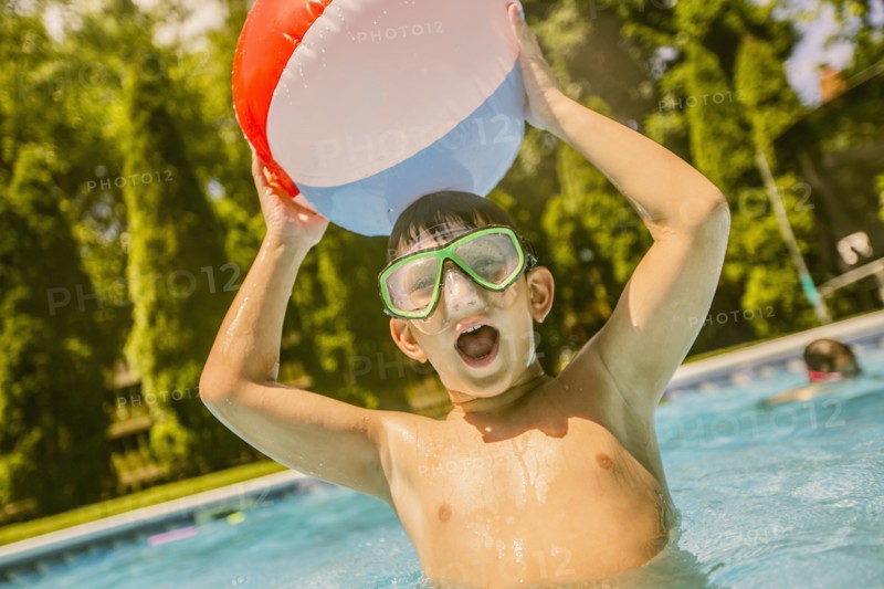 Caucasian boy playing in swimming pool