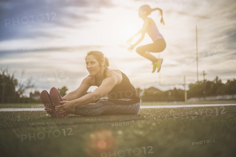 Athletes stretching on sports field