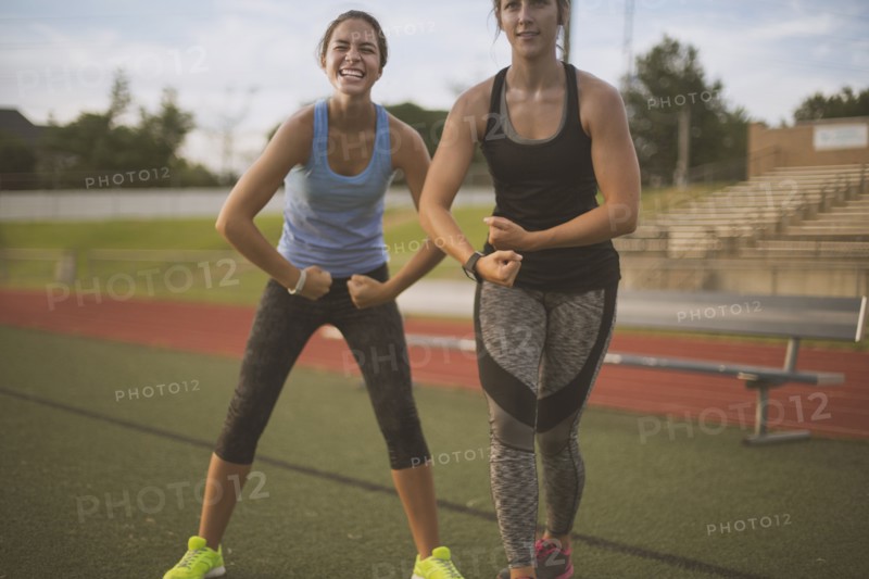 Athletes flexing their muscles on sports field