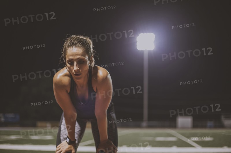 Caucasian athlete resting on sports field